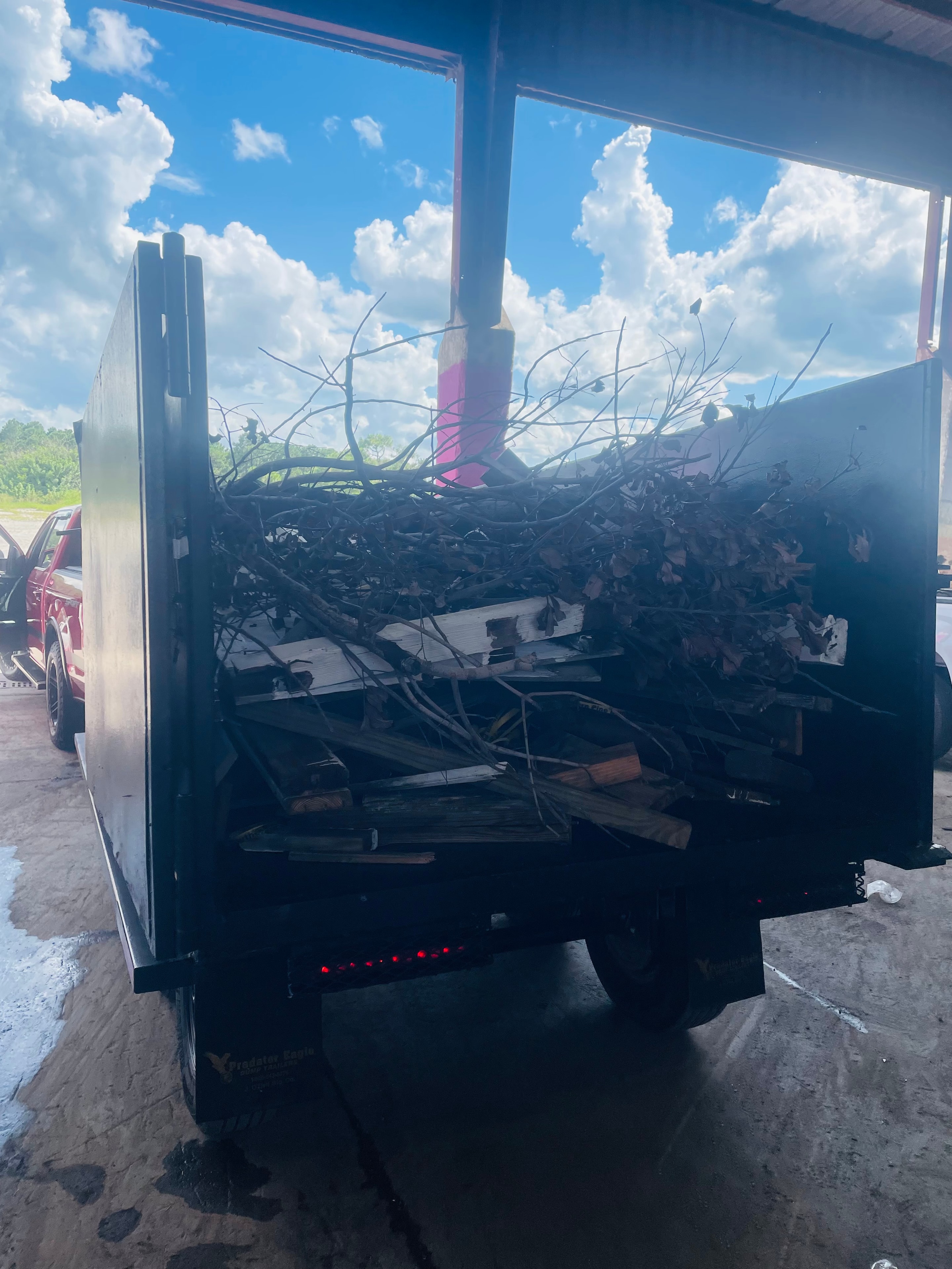 Hauling truck clearing debris at a Florida worksite